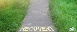 HHRC - Recovery text on a road surface surrounded by grass