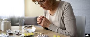 HHRC-Woman reading prescription, side effect of medication