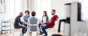 HHRC-Men and women sitting in a circle during group therapy, talking