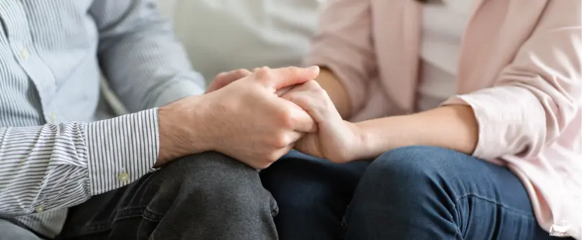 HHRC-A married couple holding each other's hands during family therapy
